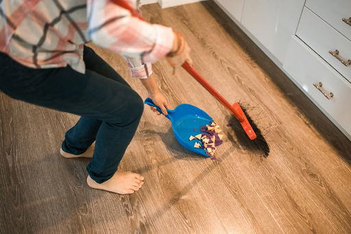 A lady cleaning the floor